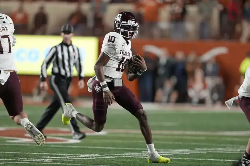 Miami - Nov 28, 2025; Austin, Texas, USA; Texas A&M Aggies quarterback Marcel Reed (10) keeps the ball for yards during the first half against the Texas Longhorns at Darrell K Royal-Texas Memorial Stadium. Mandatory Credit: Scott Wachter-Imagn Images