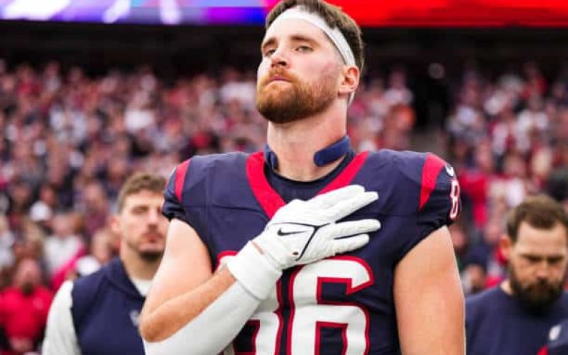 HOUSTON, TX - JANUARY 13: Dalton Schultz #86 of the Houston Texans looks on from the sideline prior to an NFL wild-card playoff football game against the Cleveland Browns at NRG Stadium on January 13, 2024 in Houston, Texas. (Photo by Cooper Neill/Getty Images)