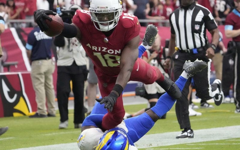 Arizona Cardinals wide receiver Marvin Harrison Jr. (18) reaches the ball over for a touchdown against Los Angeles Rams safety Kamren Curl (3) during the first quarter at State Farm Stadium on Sept. 15, 2024.