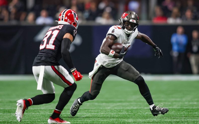 Oct 3, 2024; Atlanta, Georgia, USA; Tampa Bay Buccaneers wide receiver Chris Godwin (14) is pursued by Atlanta Falcons safety Justin Simmons (31) in the first quarter at Mercedes-Benz Stadium. Mandatory Credit: Brett Davis-Imagn Images