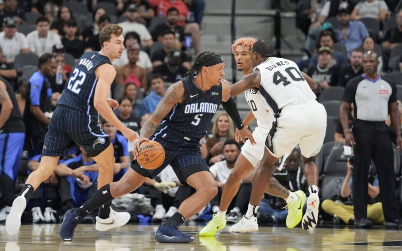 Oct 9, 2024; San Antonio, Texas, USA;  Orlando Magic forward Paolo Banchero (5) drives in against San Antonio Spurs forward Harrison Barnes (40) in the first half at Frost Bank Center. Mandatory Credit: Daniel Dunn-Imagn Images