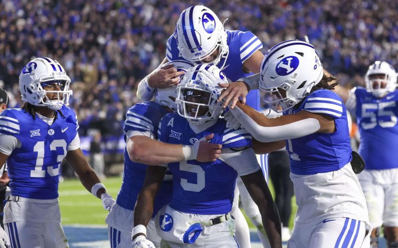 Oct 18, 2024; Provo, Utah, USA; Brigham Young Cougars wide receiver Darius Lassiter (5) celebrates a touchdown with teammates in the last minute of the game against the Oklahoma State Cowboys at LaVell Edwards Stadium. Mandatory Credit: Rob Gray-Imagn Images