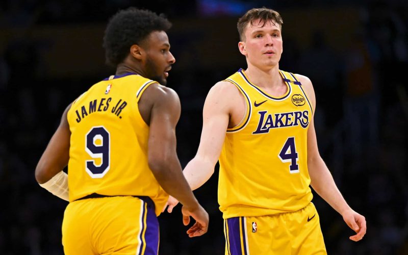 Mar 20, 2025; Los Angeles, California, USA; Los Angeles Lakers guard Dalton Knecht (4) fives guard Bronny James (9) after scoring against the Milwaukee Bucks during the second half at Crypto.com Arena. Mandatory Credit: Jonathan Hui-Imagn Images