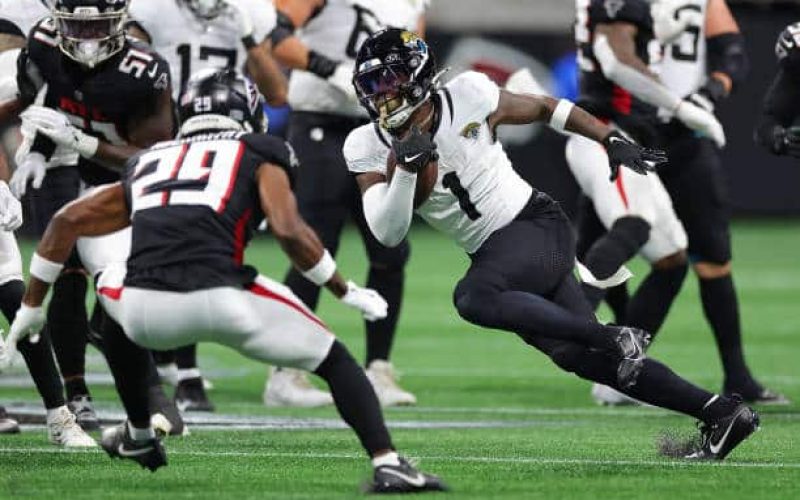 ATLANTA, GEORGIA - AUGUST 23:  Travis Etienne Jr. #1 of the Jacksonville Jaguars rushes against Micah Abernathy #29 of the Atlanta Falcons during the first quarter at Mercedes-Benz Stadium on August 23, 2024 in Atlanta, Georgia. (Photo by Kevin C. Cox/Getty Images)