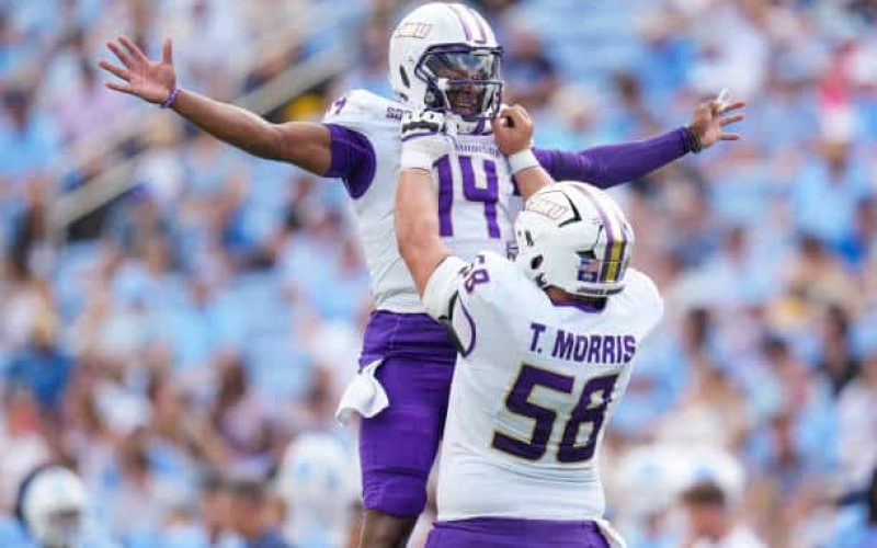CHAPEL HILL, NORTH CAROLINA - SEPTEMBER 21: Alonza Barnett III #14 celebrates with Tanner Morris #58 of the James Madison Dukes after throwing for a touchdown against the North Carolina Tar Heels during the first half of the game at Kenan Memorial Stadium on September 21, 2024 in Chapel Hill, North Carolina.  (Photo by Grant Halverson/Getty Images)